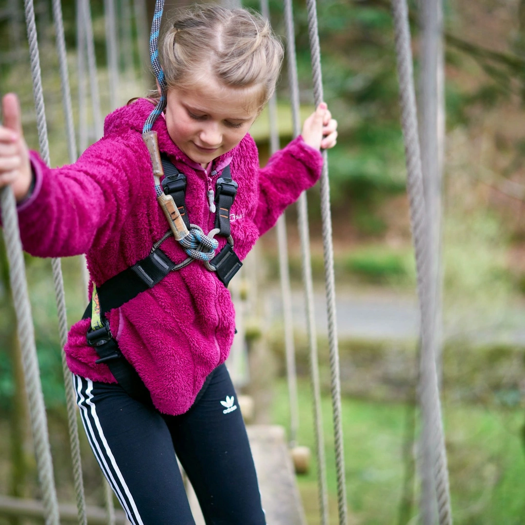 Young person on a high ropes course.