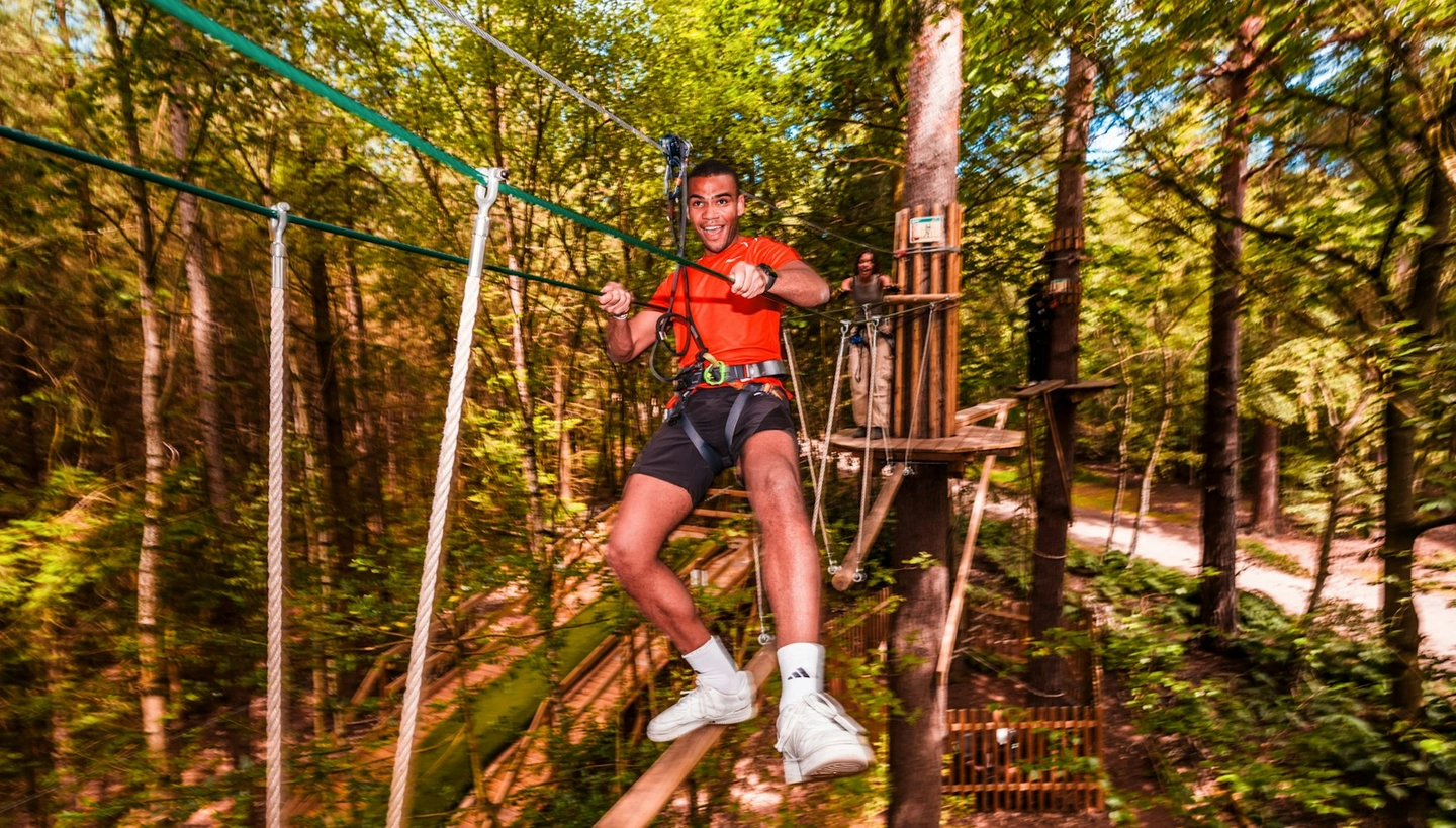 Man on high ropes crossing